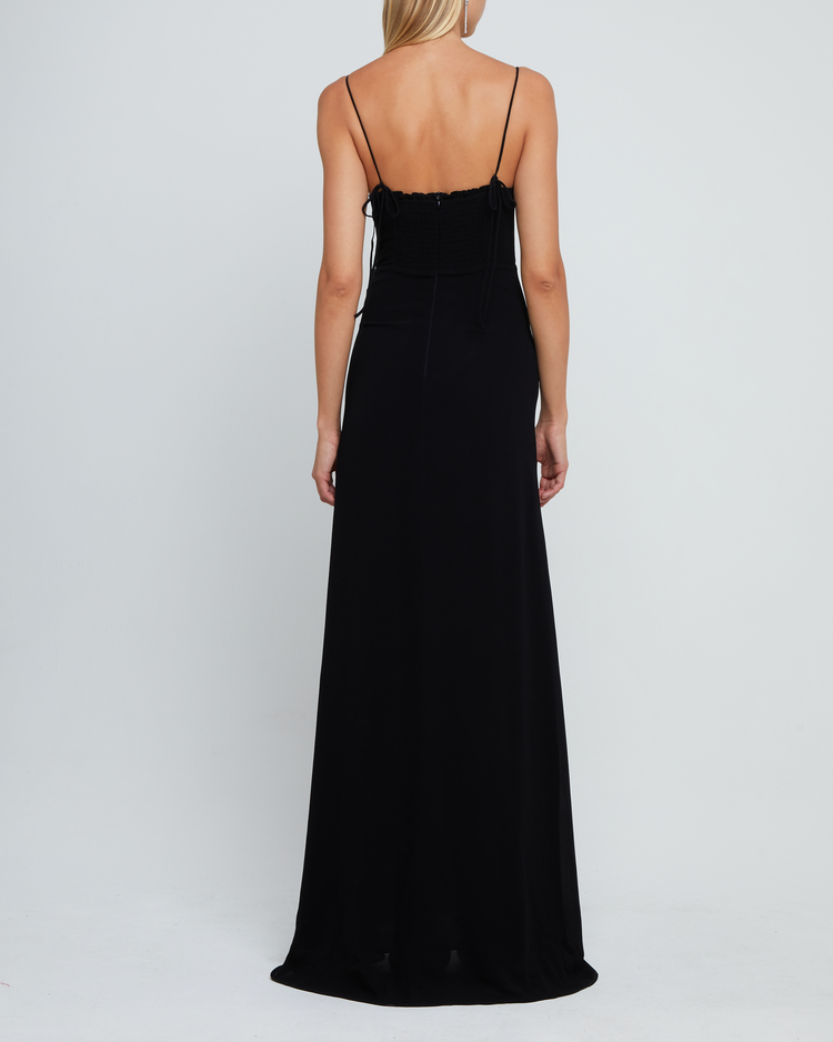 Second image of Delphi Dress, a black maxi-length bridesmaid dress with sweetheart neckline, cup detail, side slit, cupped sweetheart neckline, back zipper, back smocking, and adjustable tie string straps