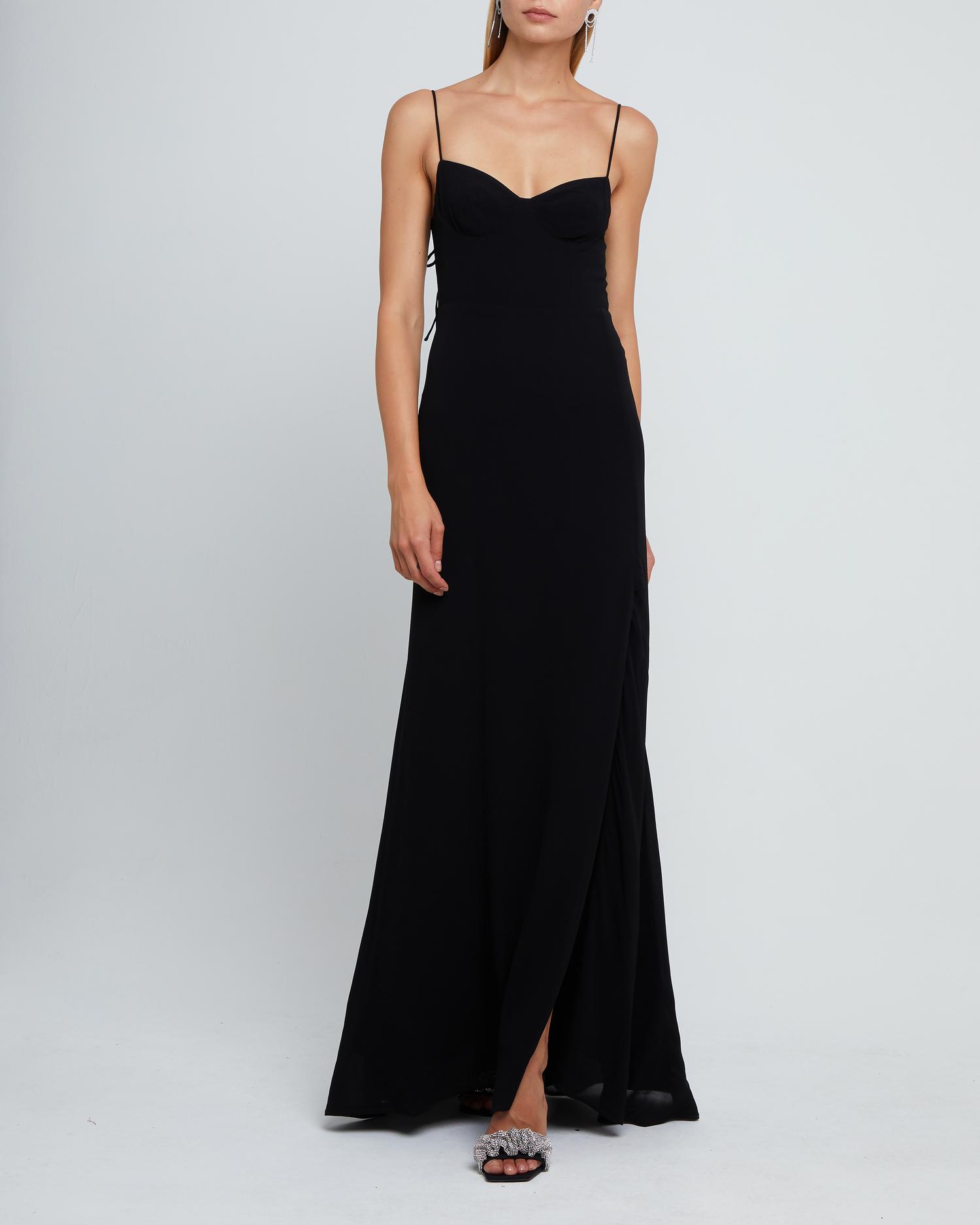 Fifth image of Delphi Dress, a black maxi-length bridesmaid dress with sweetheart neckline, cup detail, side slit, cupped sweetheart neckline, back zipper, back smocking, and adjustable tie string straps